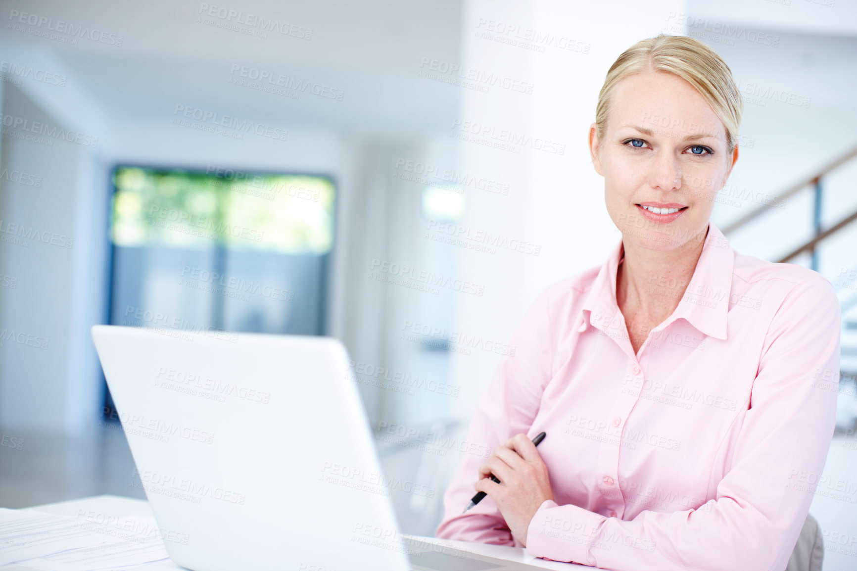 Buy stock photo An attractive female entrepreneur sitting at her desk with her laptop