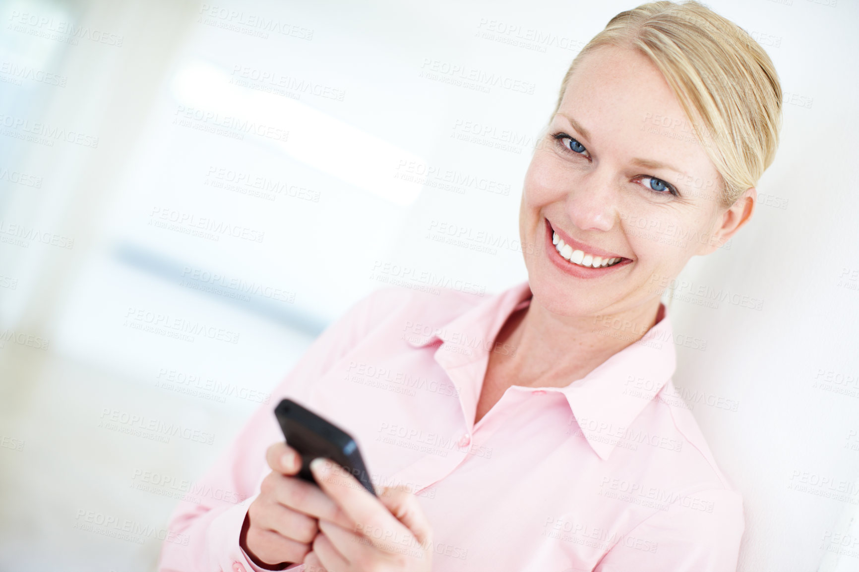 Buy stock photo Happy woman, portrait and typing with phone for communication, social media or new app at office. Young, female person or employee with smile on mobile smartphone for business chat, text or browsing