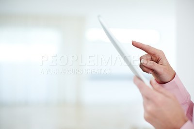 Buy stock photo Cropped shot of a businesswoman's hands touching the screen of a digital tablet