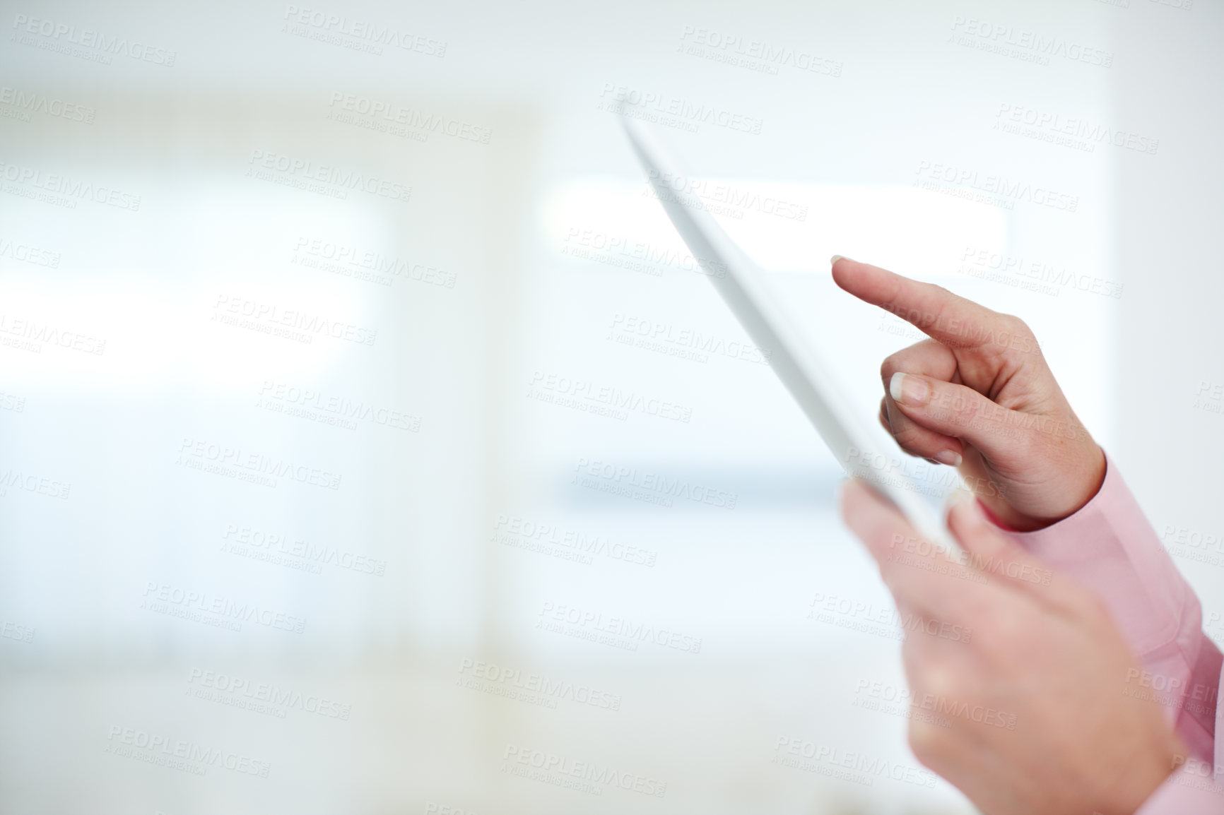 Buy stock photo Cropped shot of a businesswoman's hands touching the screen of a digital tablet