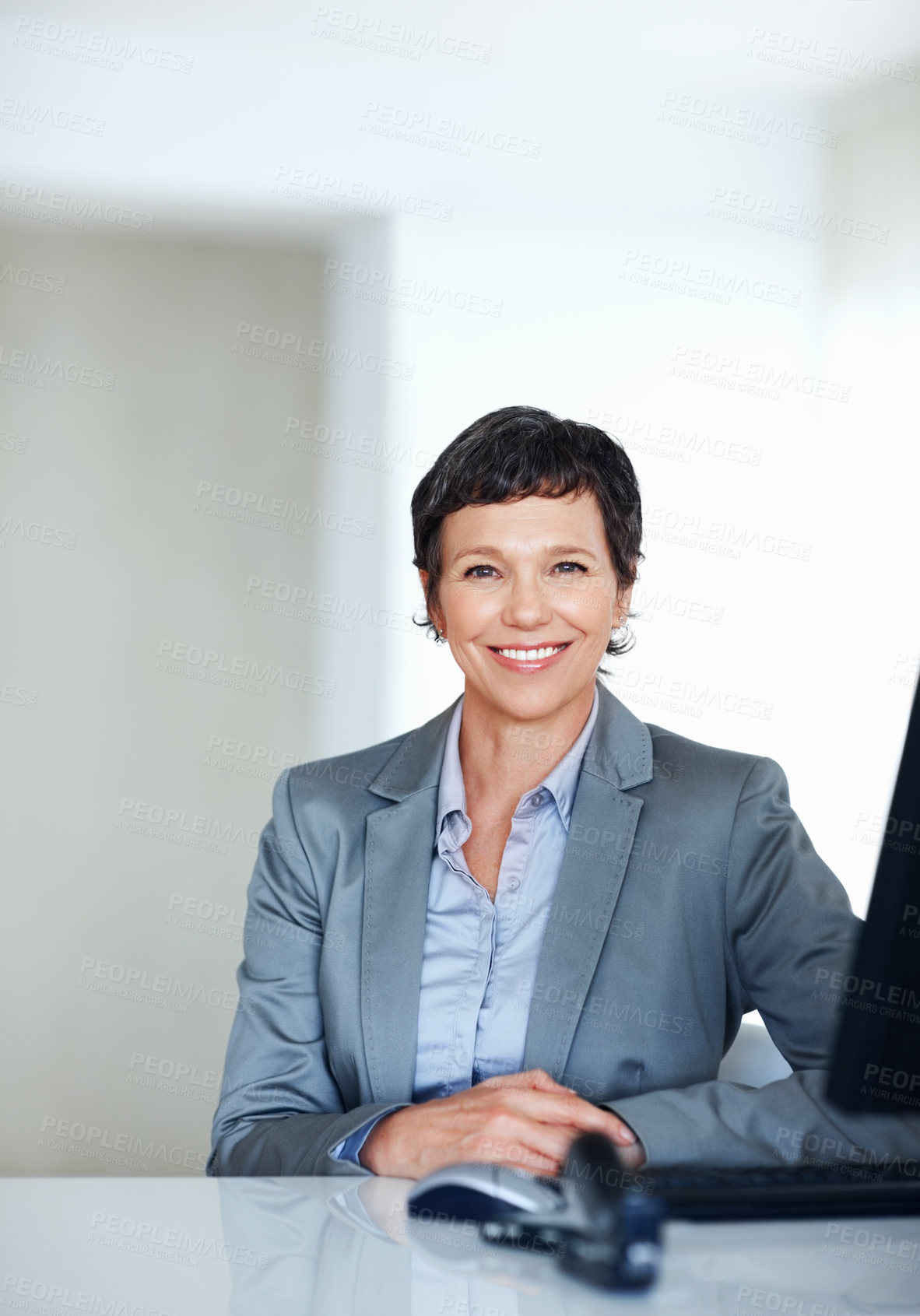 Buy stock photo Portrait of mature female executive smiling at office desk