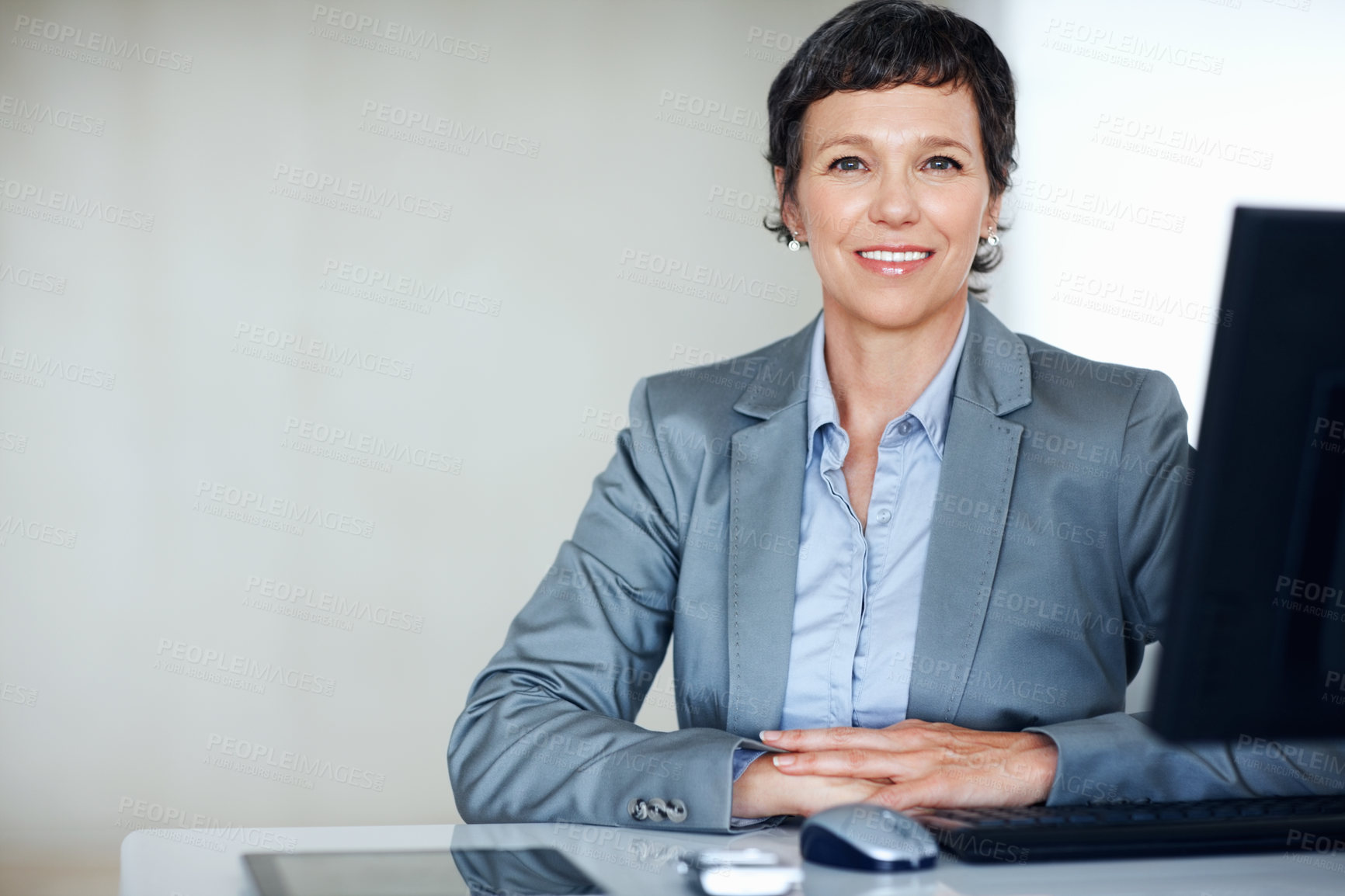 Buy stock photo Portrait of confident female executive smiling at office desk