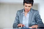 Business woman using tablet PC at work