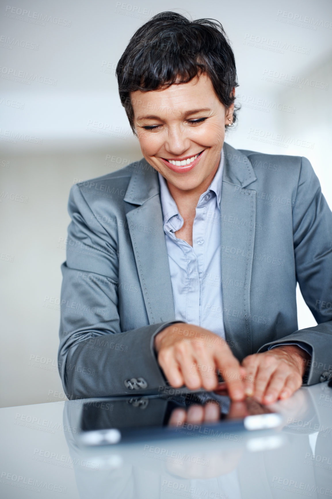 Buy stock photo Business, tablet and smile with mature woman at desk in office for professional management or research. Company, corporate and tech with confident employee person in workplace for administration