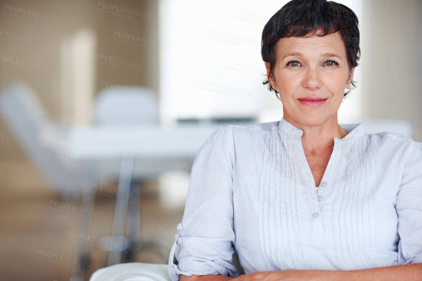 Buy stock photo Portrait of elegant female executive smiling while sitting on sofa