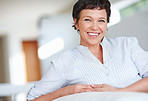 Smiling mature woman on couch