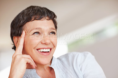 Buy stock photo Closeup of happy mature woman smiling while looking away