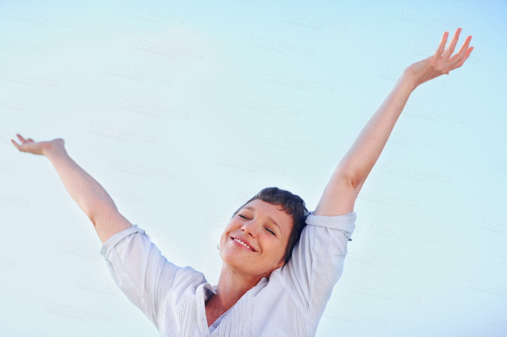 Buy stock photo Beautiful mature woman enjoying freedom outdoors with arms outstretched