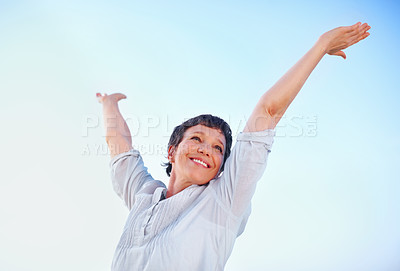 Buy stock photo Low angle view beautiful mature woman enjoying freedom outdoors with arms outstretched