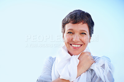 Buy stock photo Closeup of beautiful mature woman smiling against sky with scarf around her neck