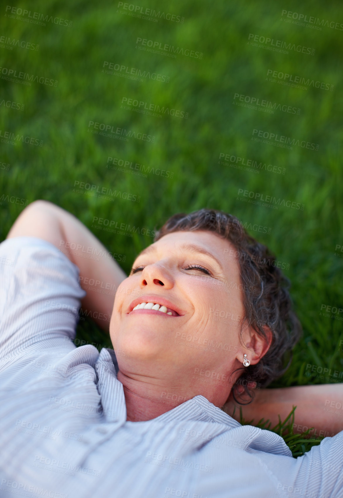 Buy stock photo Woman, smile and relax on grass space for comfort, peace and positive mental health. Calm, mature person and happy in nature park for summer travel, freedom and stressless environment for wellness