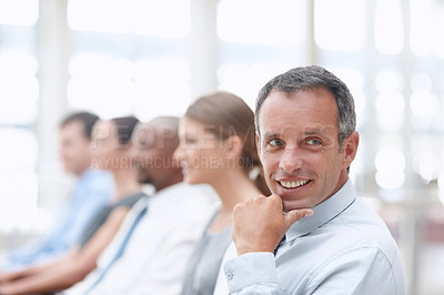 Buy stock photo Middle-aged businessman looking away while in a conference - Copyspace