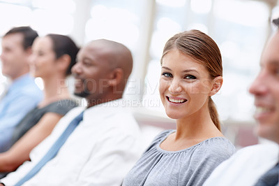 Buy stock photo Beautiful business representative smiles at you while attending a meeting