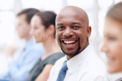 Buy stock photo Handsome African American businessman gives you a big smile while attending a conference