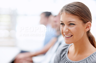 Buy stock photo Young businesswoman looks on with a smile while attending a meeting