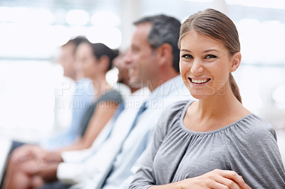 Buy stock photo Beautiful business representative smiles at you while attending a seminar
