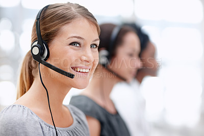 Buy stock photo Pretty young call operator smiling as she works