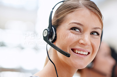 Buy stock photo Closeup of a pretty receptionist with a headset on and looking away