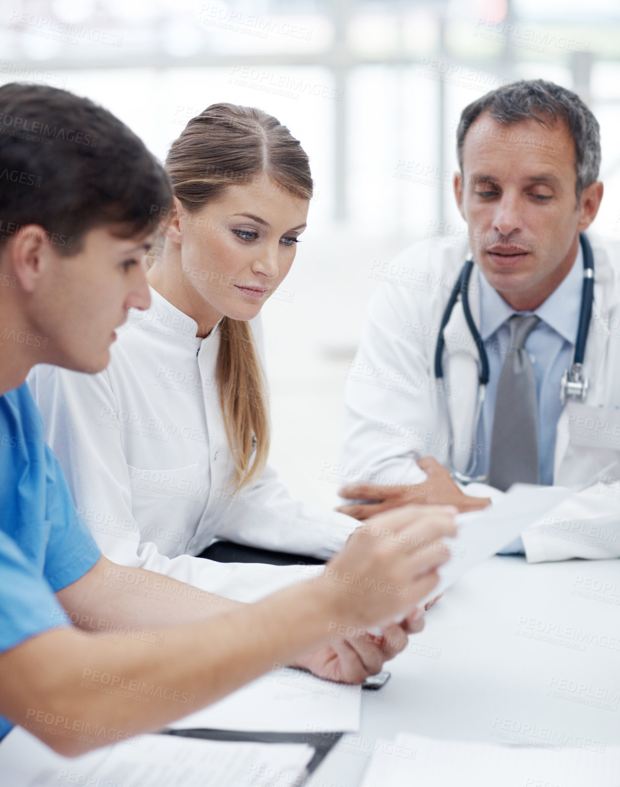Buy stock photo Doctors, group and meeting with paperwork at hospital with review, report or career in healthcare. Person, medic and scrum in boardroom at clinic for wellness, services and documentation for feedback