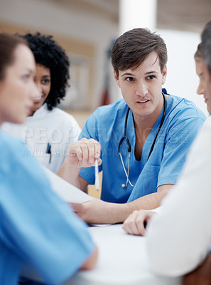 Buy stock photo Multi-racial group of healthcare professionals having a meeting
