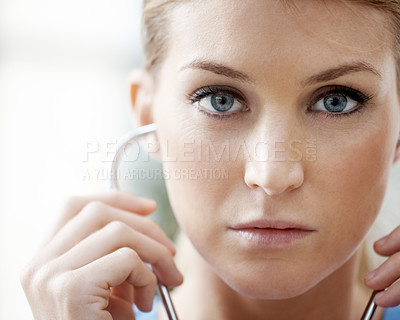 Buy stock photo Closeup of a beautiful female doctor listening through a stethoscope - portrait