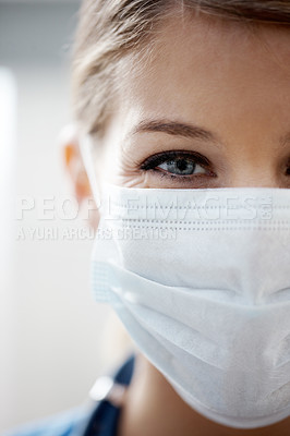 Buy stock photo Cropped image of a female surgeon wearing a surgical mask