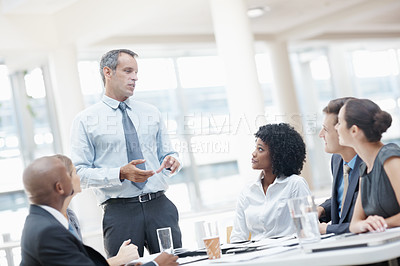 Buy stock photo Businessman, presentation and discussion with employees in meeting for corporate plan or project at office. Man, executive or speaker talking to group or team for business growth or development