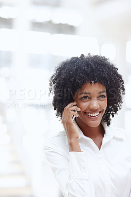 Buy stock photo A young african woman talking on her cellphone