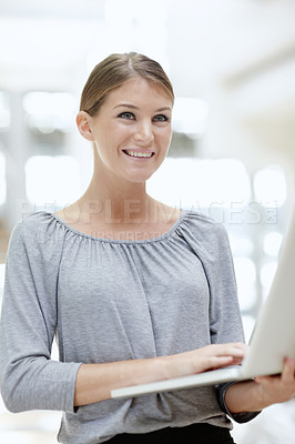 Buy stock photo An attractive young woman using her laptop in the office