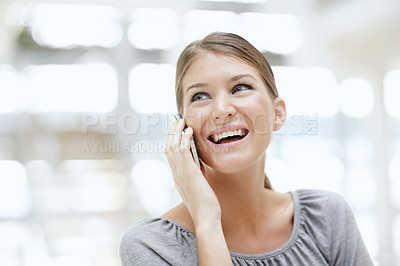 Buy stock photo An attractive young woman talking on her cellphone