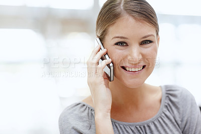 Buy stock photo Portrait of an attractive young woman talking on her cellphone