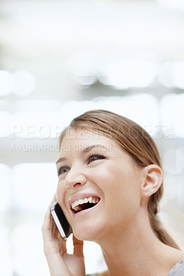 Buy stock photo A happy young woman talking on her cellphone