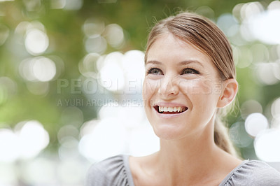 Buy stock photo An attractive young woman smiling happily