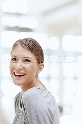 Buy stock photo A young woman smiling and looking happy 