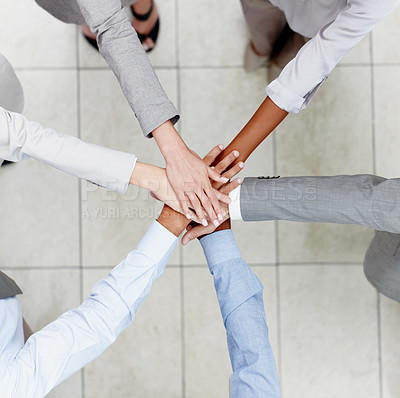 Buy stock photo Top view of diverse colleagues putting their hands together in unity 