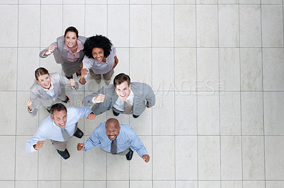Buy stock photo Top view of a triumphant business team looking up at you - Copyspace