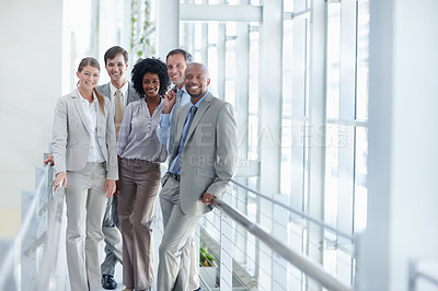 Buy stock photo Dynamic group of colleagues stand in their workplace while looking at you - Copyspace