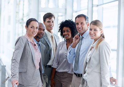 Buy stock photo Diverse business team stand closely together as they look at you
