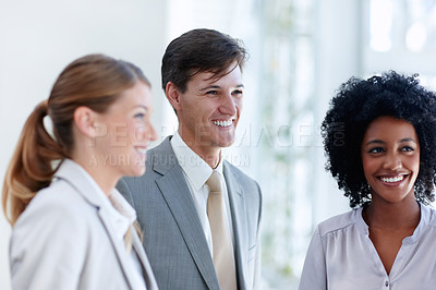 Buy stock photo Happy businessman standing beside his two female colleagues