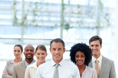 Buy stock photo Dynamic business team stand confidently with their team leader - Copyspace