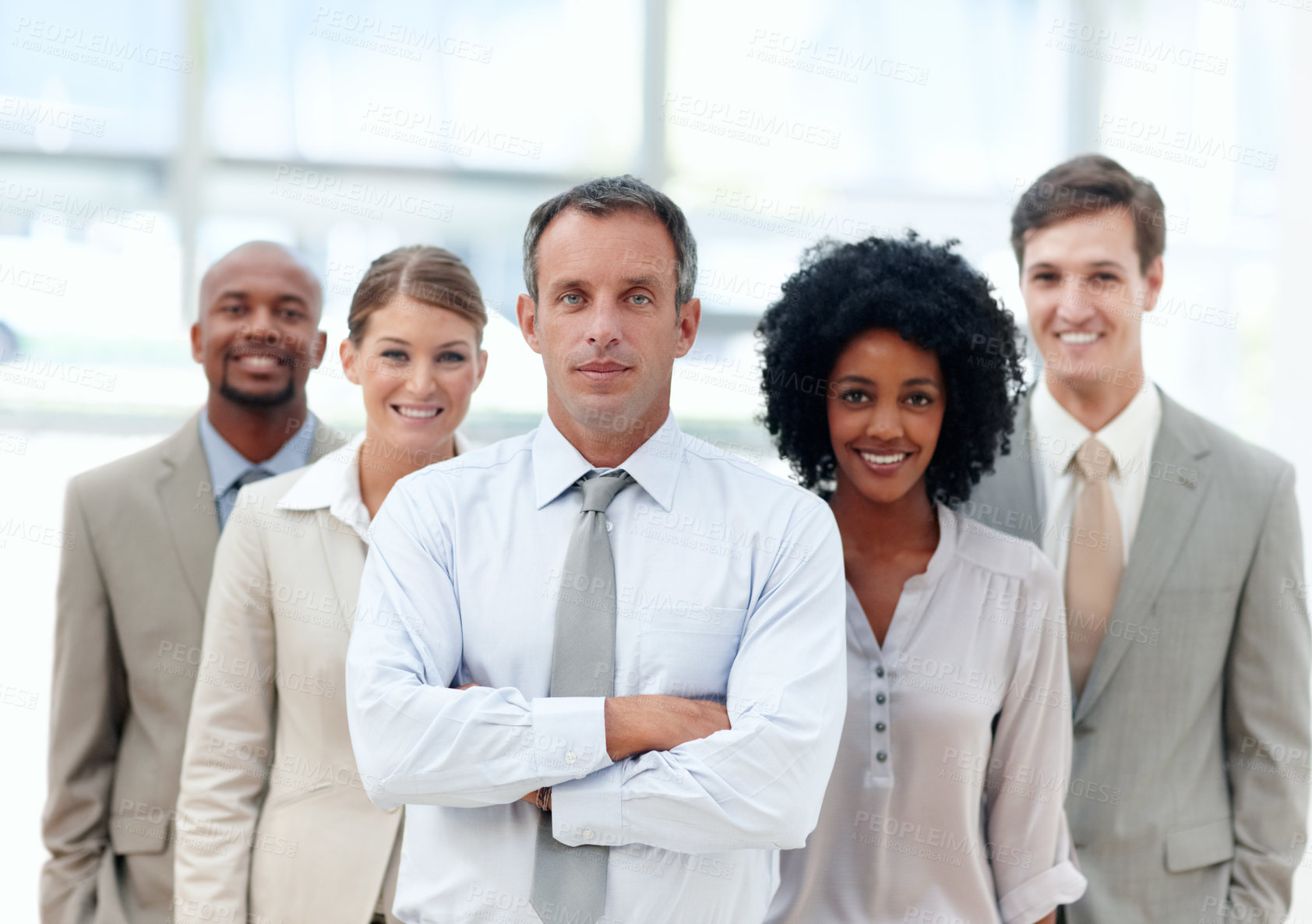 Buy stock photo Business manager stands confidently with his team behind him