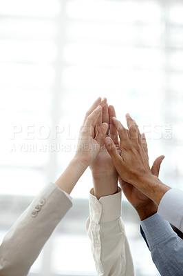Buy stock photo A group of businesspeople putting their hands together in a gesture of unity