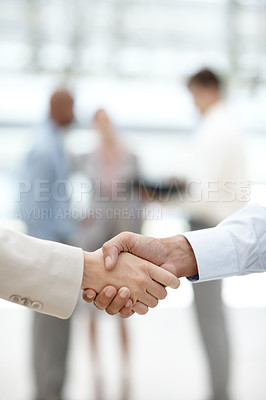 Buy stock photo Cropped view of two businesspeople shaking hands