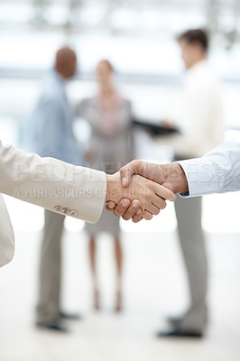 Buy stock photo Cropped view of two businesspeople shaking hands