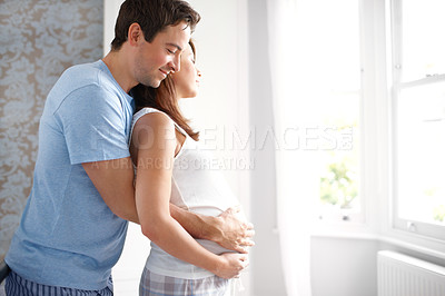 Buy stock photo Expecting loving couple looking out their bedroom window as they hold her pregnant belly 