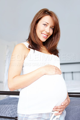 Buy stock photo Excited, motherhood and portrait of pregnant woman for responsibility, rest and stomach comfort. Smile, baby and future mother with belly, pregnancy and maternity leave to relax in home bedroom