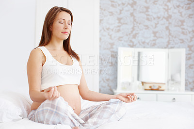 Buy stock photo Young pregnant woman meditation while sitting on her bed