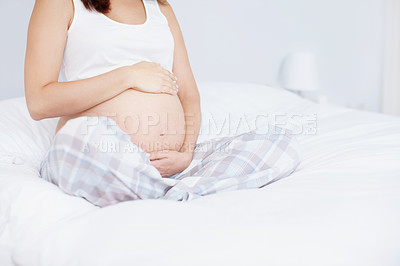 Buy stock photo Hands, bedroom and pregnant woman touch stomach for maternity, wellness and prenatal care. Pregnancy, mother and holding tummy for baby expectation, future development and growth at home to relax