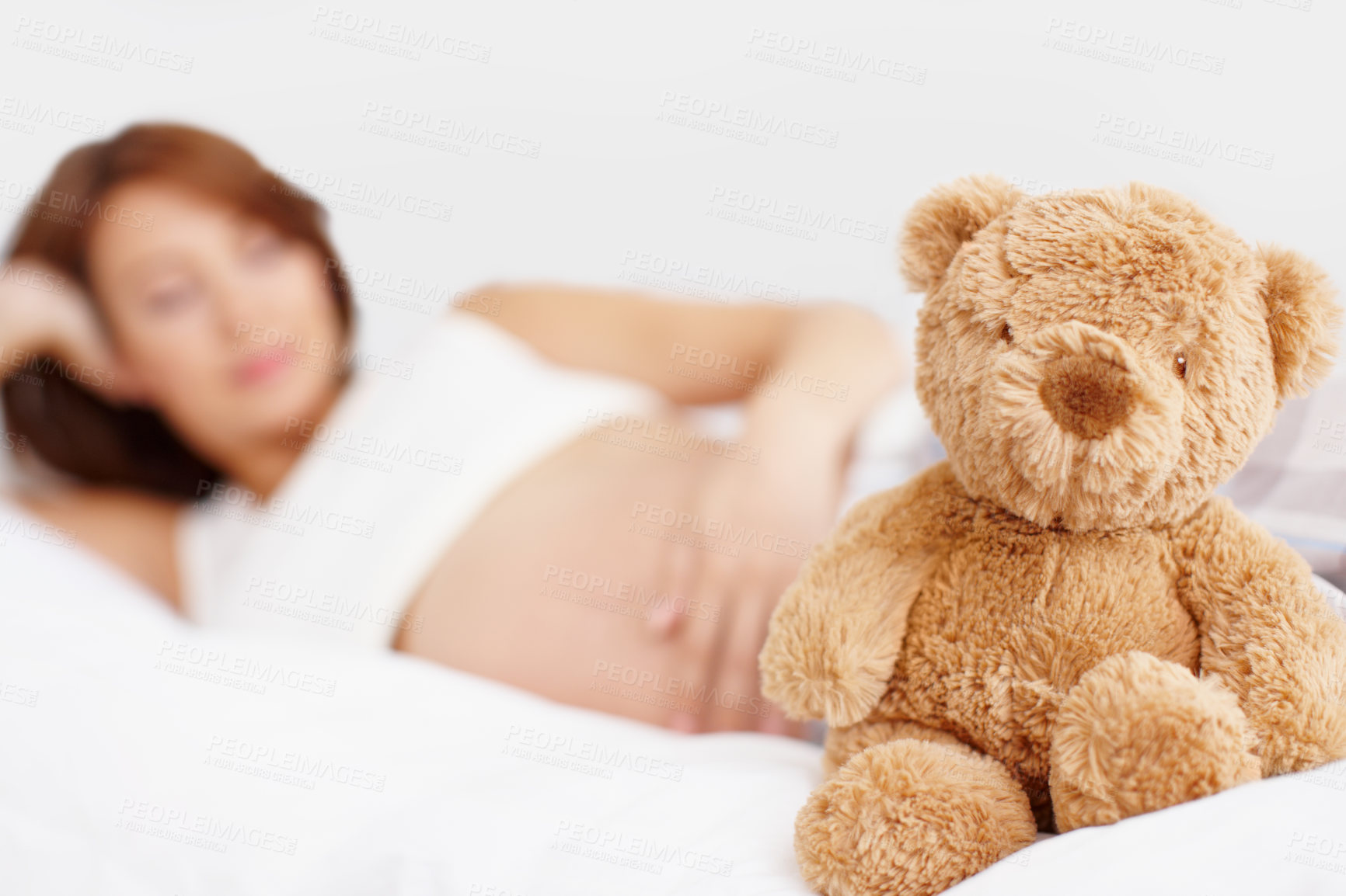 Buy stock photo Pregnant woman, teddy bear and rest in bedroom with break, comfort and fatigue for baby development. Female person, stomach and tired as mother for growth on weekend for relax, peace and calm in home