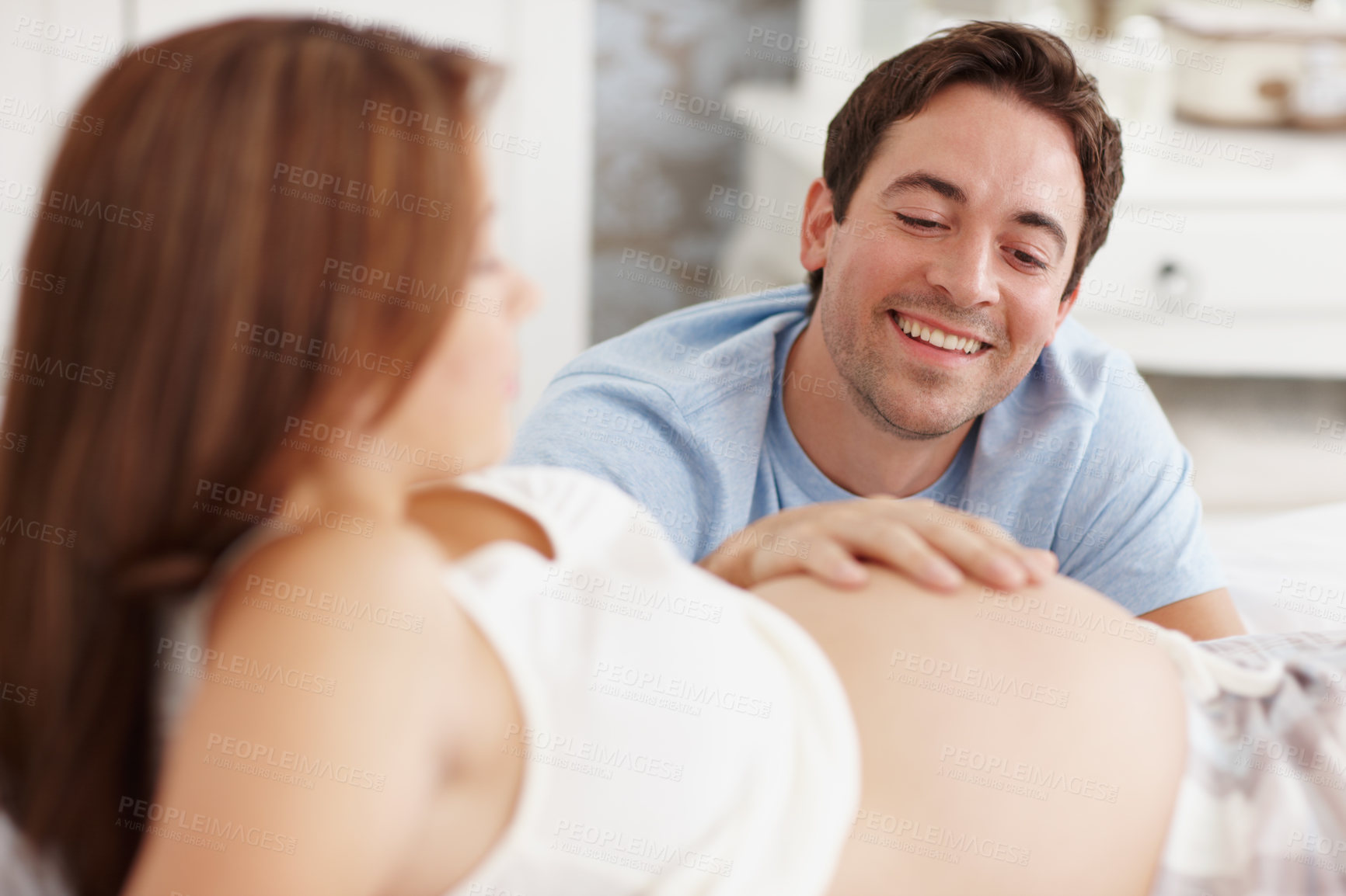 Buy stock photo Couple, bonding and pregnant with stomach, touch and happy in home for future motherhood support. People, smile and healthy pregnancy development for prenatal care, maternity and growth with relax